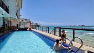 Signature craft cocktail garnished with fresh fruit at the Coral Rock by Bansei bar.